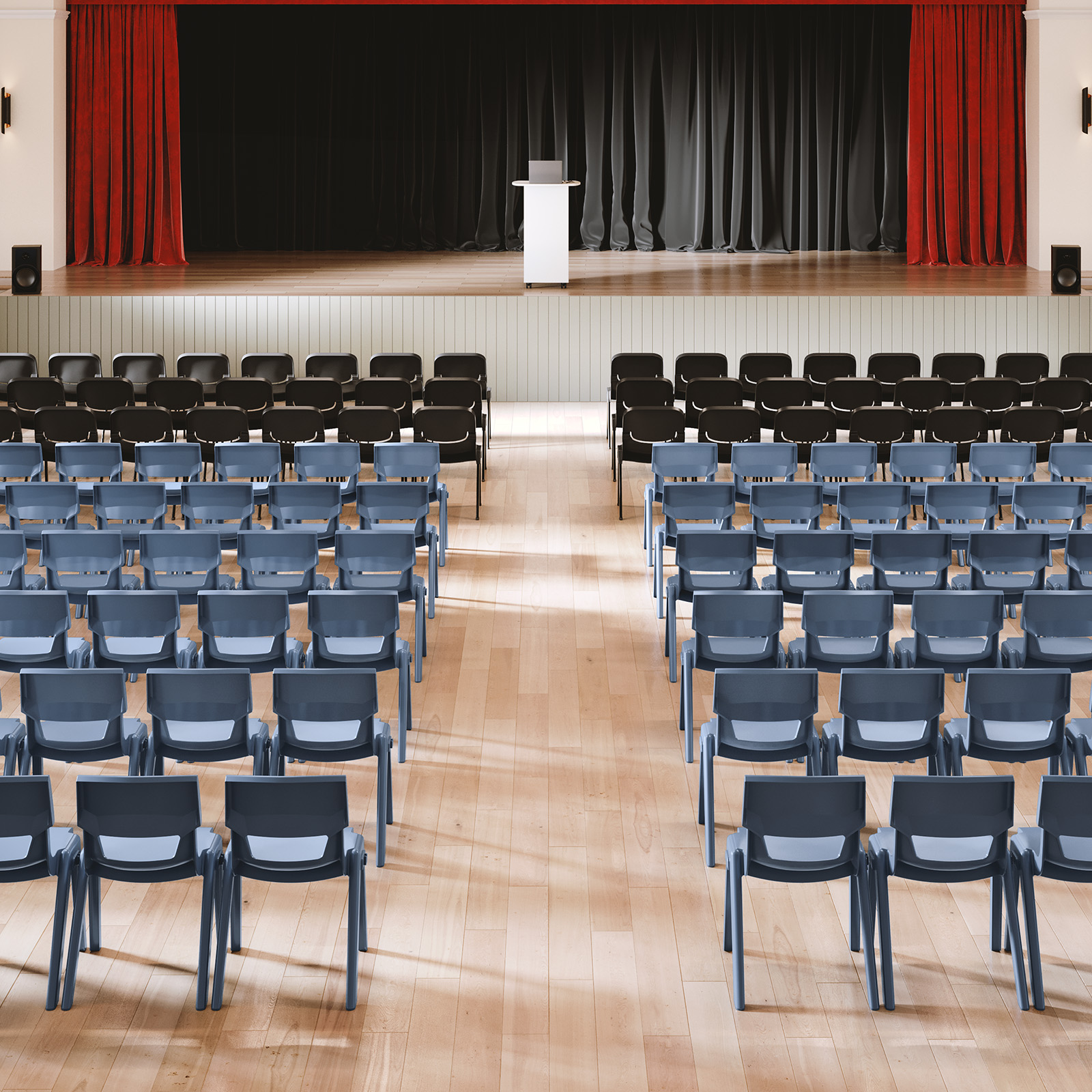 School assembly hall with flexible student seating and stage presentation area