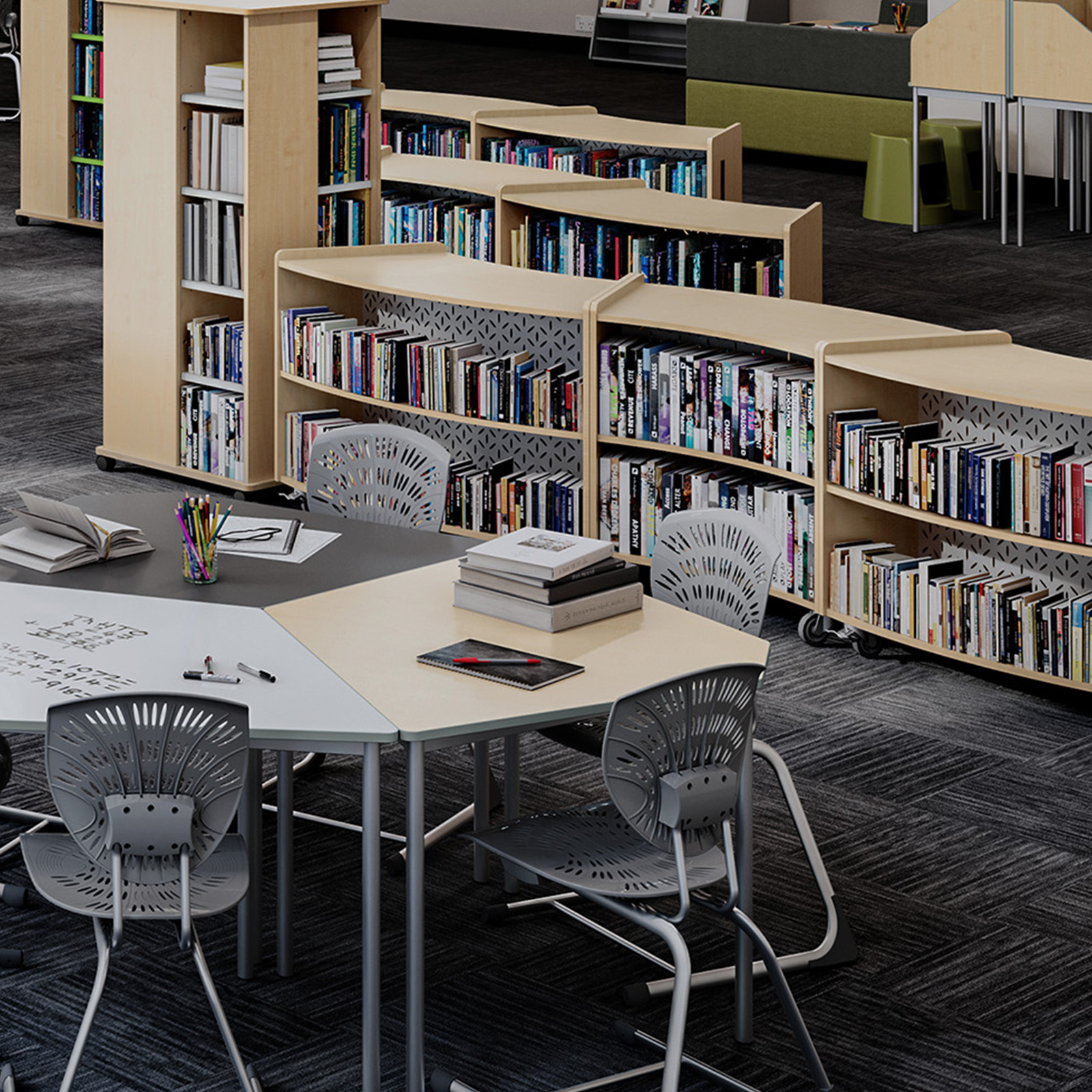 School library and breakout learning space with modular shelving, collaborative tables and student seating