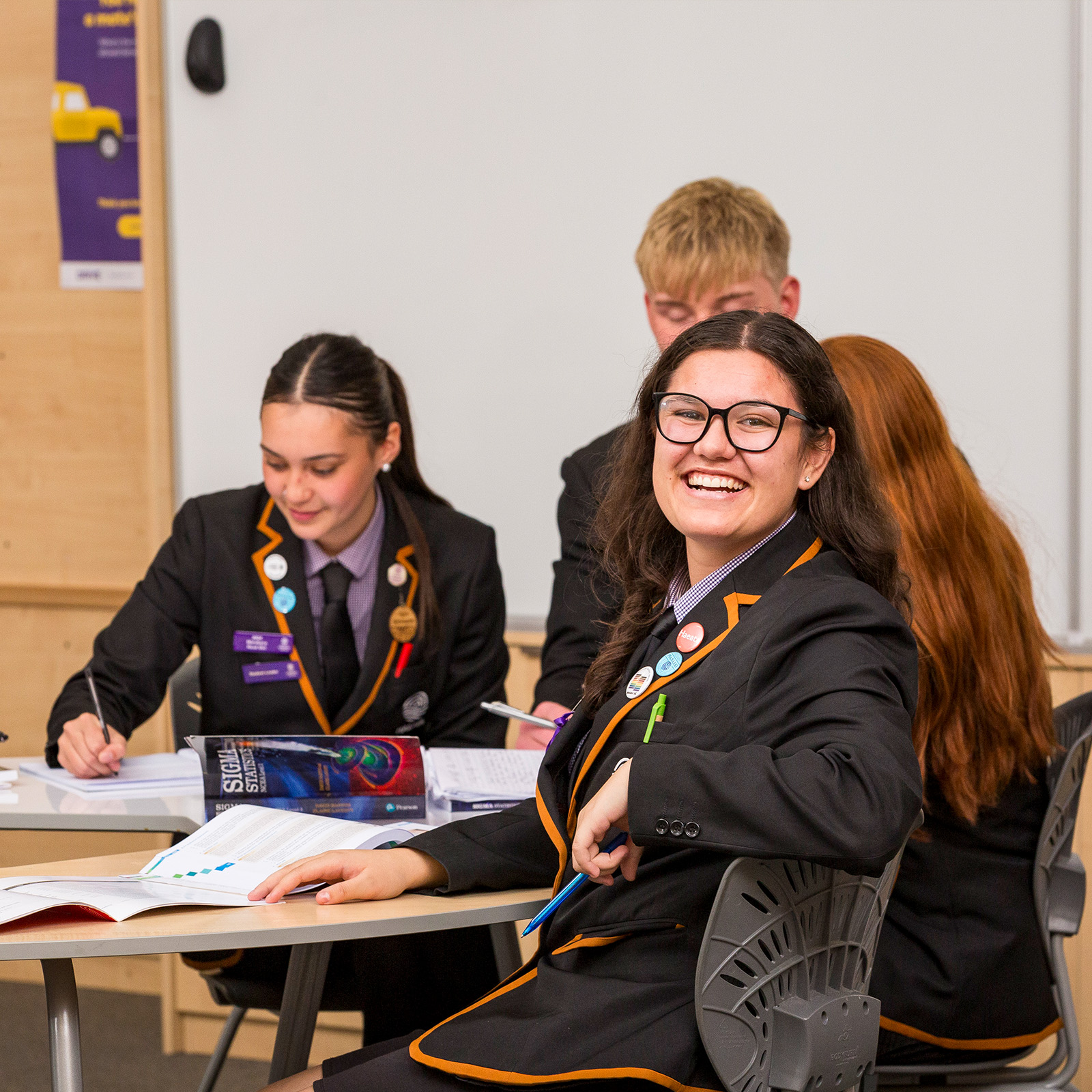 Secondary students seated at desks using classroom furniture in a collaborative learning space.