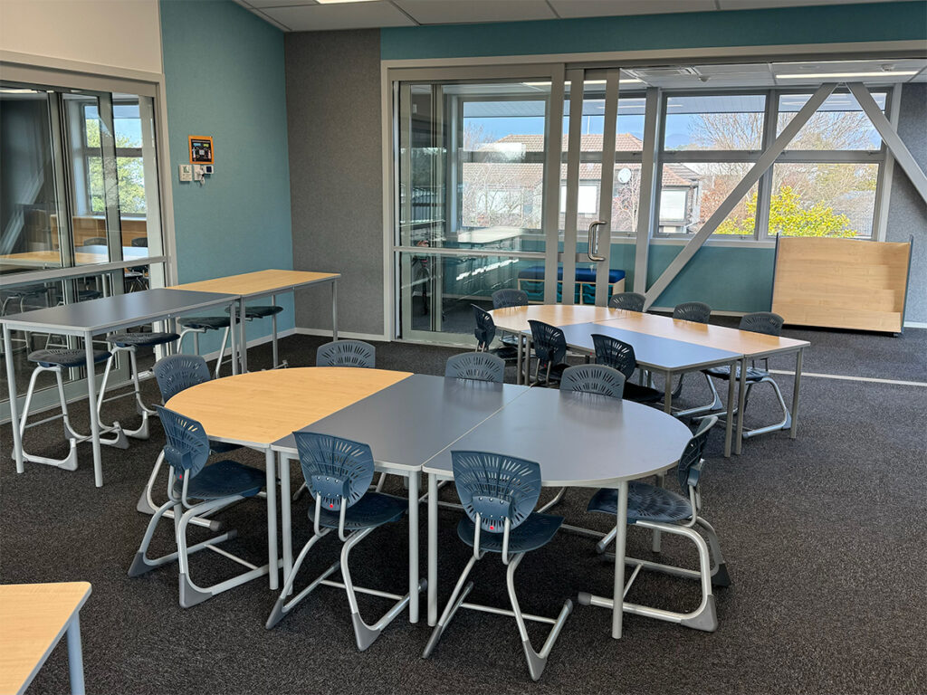 D tables and rectangular tables with Bodyfurn sled chairs and lab stools at Elmwood Normal School.