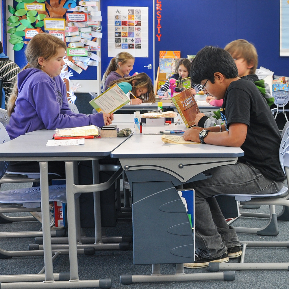 Students using Bodyfurn chairs and desks during a classroom lesson