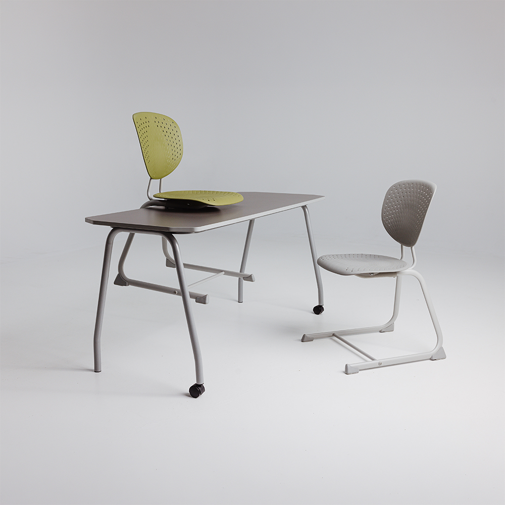 Bodyfurn Flex sled chairs in forest green and basalt grey arranged around a Switch table